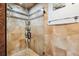 Tiled shower with glass door, showcasing modern fixtures and design at 17301 Estes Rd, Lutz, FL 33548