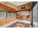 The sunroom is lined with wood paneling and large windows, offering a bright and airy space at 17301 Estes Rd, Lutz, FL 33548