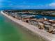 Breathtaking aerial view of a vibrant coastline with pristine beaches, a winding river, and lush greenery at 19700 Gulf Blvd # 403, Indian Shores, FL 33785