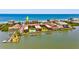 Aerial view of complex highlighting water access, boat docks, beach access and swimming pool at 19700 Gulf Blvd # 403, Indian Shores, FL 33785