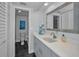 Well-lit bathroom with modern fixtures, a large mirror, and a vanity with ample storage space at 19700 Gulf Blvd # 403, Indian Shores, FL 33785
