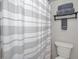 Bathroom shower and toilet area showing stacked grey towels and a toilet at 19700 Gulf Blvd # 403, Indian Shores, FL 33785