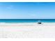A peaceful sandy beach with crystal-clear turquoise water is perfect for relaxing and enjoying the sunshine at 19700 Gulf Blvd # 403, Indian Shores, FL 33785