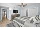 Comfortable bedroom with a large bed, wood-look flooring, and a view of the ocean from the doorway at 19700 Gulf Blvd # 403, Indian Shores, FL 33785