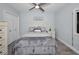 Comfortable bedroom with light colored walls, wood toned floors, a fan, and a plush comforter at 19700 Gulf Blvd # 403, Indian Shores, FL 33785