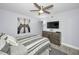 Bedroom featuring a gray striped bedspread, ceiling fan and a Brooklyn Bridge art piece at 19700 Gulf Blvd # 403, Indian Shores, FL 33785