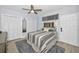 Bedroom featuring a gray striped comforter, wood-look floors, and double closets at 19700 Gulf Blvd # 403, Indian Shores, FL 33785