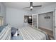 Bright bedroom with a striped bedspread, ceiling fan and a view from the window at 19700 Gulf Blvd # 403, Indian Shores, FL 33785