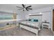 Bright bedroom featuring a platform bed, ceiling fan, wood floors, and a view of the ocean at 19700 Gulf Blvd # 403, Indian Shores, FL 33785