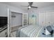 Bright bedroom featuring neutral tones, tile floors, and a fan for added comfort at 19700 Gulf Blvd # 403, Indian Shores, FL 33785