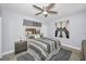 Comfortable bedroom featuring a ceiling fan, gray toned decor and unique artwork above the bed at 19700 Gulf Blvd # 403, Indian Shores, FL 33785