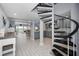 Open-concept entryway featuring spiral staircase, grey cabinetry, and views of the ocean at 19700 Gulf Blvd # 403, Indian Shores, FL 33785