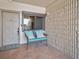 Welcoming entryway with a bench, decorative pillows, and textured wall with a window to the outside at 19700 Gulf Blvd # 403, Indian Shores, FL 33785