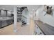 Hallway with updated kitchen, spiral staircase, and designer coastal decorations at 19700 Gulf Blvd # 403, Indian Shores, FL 33785