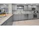 Updated kitchen featuring gray cabinets, stainless steel appliances, and mosaic tile backsplash at 19700 Gulf Blvd # 403, Indian Shores, FL 33785