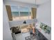 Living room with large windows overlooking the beach, stylish decor, and comfortable seating at 19700 Gulf Blvd # 403, Indian Shores, FL 33785