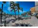 Inviting pool area surrounded by tropical palms and lounging areas, perfect for relaxation at 19700 Gulf Blvd # 403, Indian Shores, FL 33785