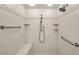 Bright tile shower with built-in seat and safety bars at 19700 Gulf Blvd # 403, Indian Shores, FL 33785