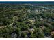 High altitude aerial view of a residential community with established trees, and suburban streets at 20 Willowwood Ln, Oldsmar, FL 34677