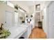 Bright bathroom featuring double sinks, tile flooring, and large mirror at 20 Willowwood Ln, Oldsmar, FL 34677