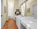 Bright bathroom featuring single sink, tile flooring, and large mirror at 20 Willowwood Ln, Oldsmar, FL 34677