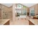 Bright bathroom with a soaking tub under a large window and a glass enclosed shower at 20 Willowwood Ln, Oldsmar, FL 34677