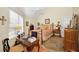 Bedroom featuring decorative rug, desk, and brass bed with floral bedding at 20 Willowwood Ln, Oldsmar, FL 34677