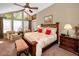 Comfortable bedroom featuring high ceilings, seating, and a large window offering beautiful views at 20 Willowwood Ln, Oldsmar, FL 34677