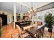 Spacious dining room with chandelier, terra cotta tile floor, and easy access to outdoor pool at 20 Willowwood Ln, Oldsmar, FL 34677