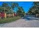 Elegant stone entrance with a gate and lush landscaping, showcasing the community's name at 20 Willowwood Ln, Oldsmar, FL 34677
