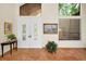 Bright, neutral foyer featuring white double doors, transom window and terra cotta tiled floors at 20 Willowwood Ln, Oldsmar, FL 34677