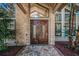 Stately double doors and detailed brickwork give this home charming curb appeal at 20 Willowwood Ln, Oldsmar, FL 34677