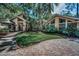 Lush front lawn with mature palms and plantings enhance this spacious, bright single Gathering home at 20 Willowwood Ln, Oldsmar, FL 34677