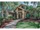 Attractive home featuring unique architectural details and mature landscaping around the grounds at 20 Willowwood Ln, Oldsmar, FL 34677