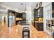 View of the kitchen featuring an island, stainless steel appliances and barstool seating at 20 Willowwood Ln, Oldsmar, FL 34677