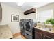 Well-equipped laundry room with granite countertop, storage cabinets, and modern washer/dryer at 20 Willowwood Ln, Oldsmar, FL 34677