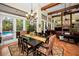 Open-concept living area with high ceilings, and large windows overlooking backyard pool at 20 Willowwood Ln, Oldsmar, FL 34677