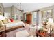 Tranquil main bedroom with vaulted ceiling, neutral color palette, and seating area at 20 Willowwood Ln, Oldsmar, FL 34677