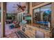Covered patio featuring an outdoor kitchen and bar with stainless steel appliances at 20 Willowwood Ln, Oldsmar, FL 34677
