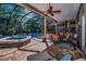 Screened patio with an outdoor kitchen, dining area, and inground pool at 20 Willowwood Ln, Oldsmar, FL 34677