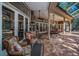 Covered patio with brick flooring, ceiling fans, outdoor kitchen and seating area at 20 Willowwood Ln, Oldsmar, FL 34677