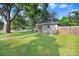 Well-maintained home with a spacious lawn, complemented by mature trees and a fenced yard at 2001 E Idlewild Ave, Tampa, FL 33610