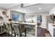 Charming kitchen featuring a breakfast bar, modern appliances, and an open layout with views of the bedroom at 2001 E Idlewild Ave, Tampa, FL 33610