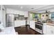 Bright kitchen featuring white cabinetry, stainless steel appliances, and sleek countertops, perfect for culinary enthusiasts at 2001 E Idlewild Ave, Tampa, FL 33610