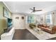 Open-concept living room featuring dark hardwood floors and a comfortable seating area at 2001 E Idlewild Ave, Tampa, FL 33610