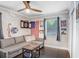 Cozy living room featuring a comfortable sofa, a dart board, and patriotic decor providing a welcoming atmosphere at 2001 E Idlewild Ave, Tampa, FL 33610