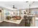 Bright living room with dark hardwood floors, modern decor, and ample natural light at 2001 E Idlewild Ave, Tampa, FL 33610