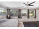 Serene bedroom with large windows, neutral tones, ceiling fan, and ample natural light creating a cozy retreat at 2001 E Idlewild Ave, Tampa, FL 33610