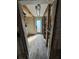 Hallway under construction with new flooring leading to an inviting, light blue back door for a fresh start at 204 162Nd Ave, Redington Beach, FL 33708
