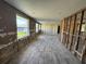 Bright living room with large windows, contemporary flooring and exposed framing for easy renovation at 204 162Nd Ave, Redington Beach, FL 33708